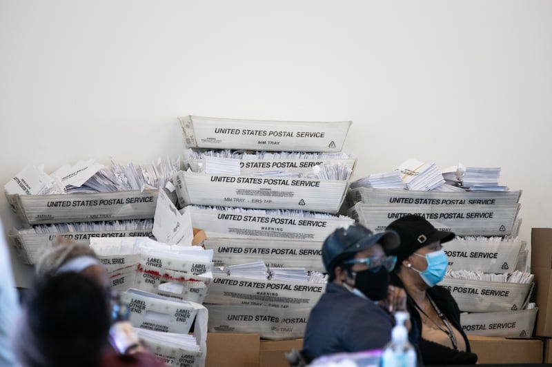 Security envelopes for absentee ballots sit in stacked boxes as Fulton county workers continue to count absentee ballots at State Farm Arena on November 6, 2020 in Atlanta, Georgia. Photo by Jessica McGowan/Getty Images.