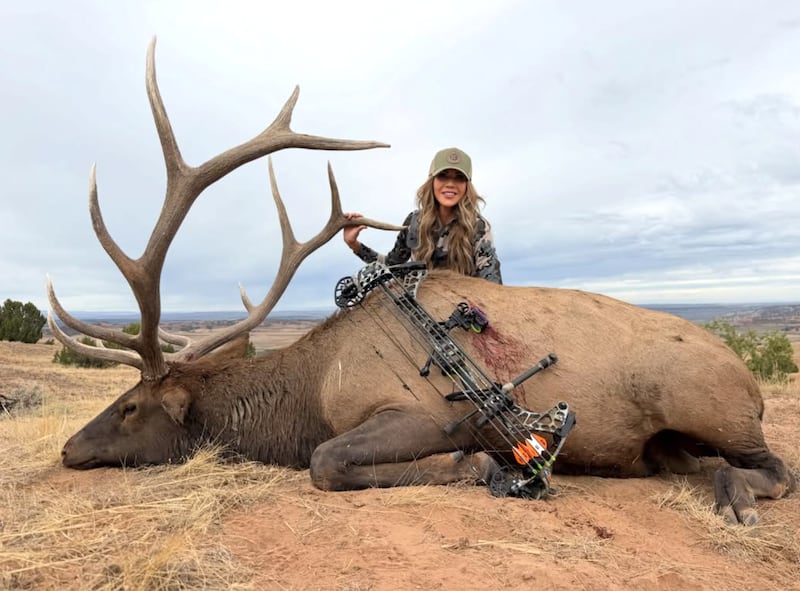 Kristi Noem poses with the elk she killed.