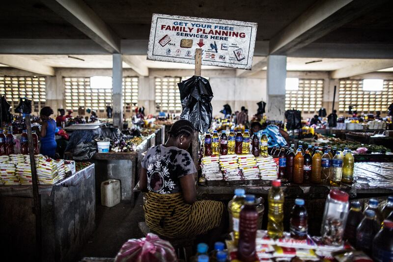TOPSHOT - A woman sits by her stall in the Jorkpan market at Sinkor district in Monrovia, on May 2, 2016. Family planning services, like contraceptives and counselling are available in the markets in Liberia, an initiative that is aimed at tackling the high adolescent pregnancy rate in the younger population. (Photo by MARCO LONGARI / AFP) (Photo by MARCO LONGARI/AFP via Getty Images)
