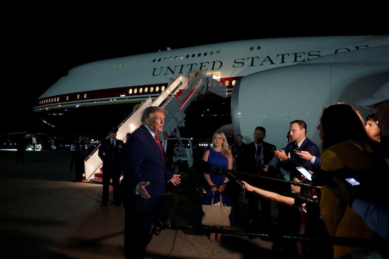 U.S. President Donald Trump speaks to members of the media after disembarking Air Force One at Joint Base Andrews, Maryland, U.S., August 11, 2026.