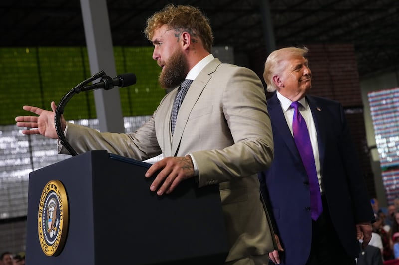 HEBRON, KENTUCKY - MARCH 11: Jake Paul (L) speaks as U.S. President Donald Trump watches on stage at Verst Logistics on March 11, 2026 in Hebron, Kentucky. Verst Logistics handles packaging, shrink sleeve labeling, and transportation management for various brands. (Photo by Andrew Harnik/Getty Images)