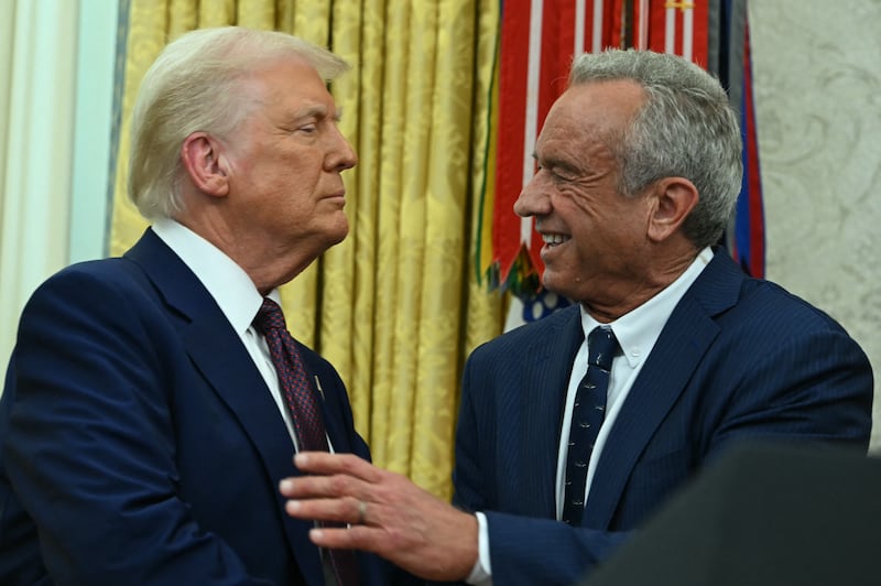 US Secretary of Health and Human Services Robert F. Kennedy Jr. shakes hands with US President Donald Trump.