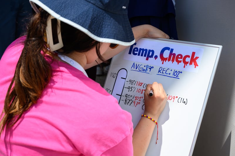A person records the extreme heat at the Great American State Fair as temperatures reach above 100 degrees Fahrenheit on the National Mall  on July 03, 2026 in Washington, DC.