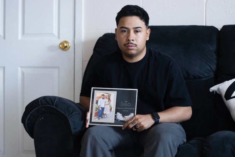 An army sergeant holds a picture of his deported wife.