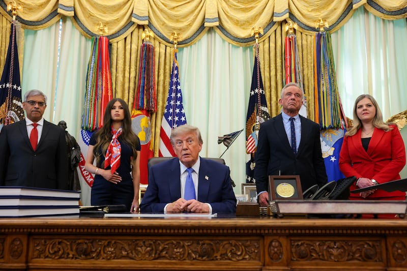 WASHINGTON, DC - AUGUST 10: U.S. President Donald Trump, accompanied by (L-R) National Institutes of Health Director Jay Bhattacharya, Jayme Leagh Franklin with the The Conservateur, Health and Human Services Secretary Robert F. Kennedy Jr., and Deputy Assistant to the President for Domestic Policy Dr. Heidi Overton, takes a question from reporters after Trump signed an exeutive order calling for childhood vaccine shots to be spaced out into separate visits during an event in the Oval Office of the White House on August 10, 2026 in Washington, DC. (Photo by Anna Moneymaker/Getty Images)