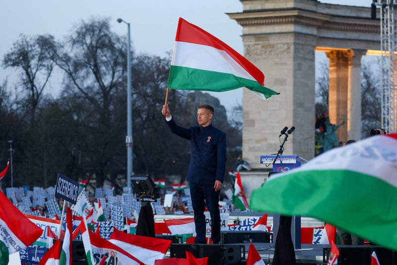 Peter Magyar, leader of the opposition Tisza party, holds a Hungarian flag during Hungary's National Day celebrations, which also commemorates the 1848 Hungarian Revolution against Habsburg rule, in Budapest, Hungary, March 15, 2026.