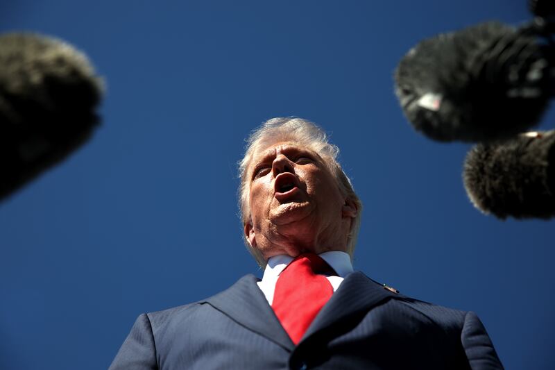 President Donald Trump speaks to reporters as he arrives at Palm Beach International Airport on October 31, 2025 in West Palm Beach, Florida. Trump is spending the weekend at his Mar-A-Lago estate.