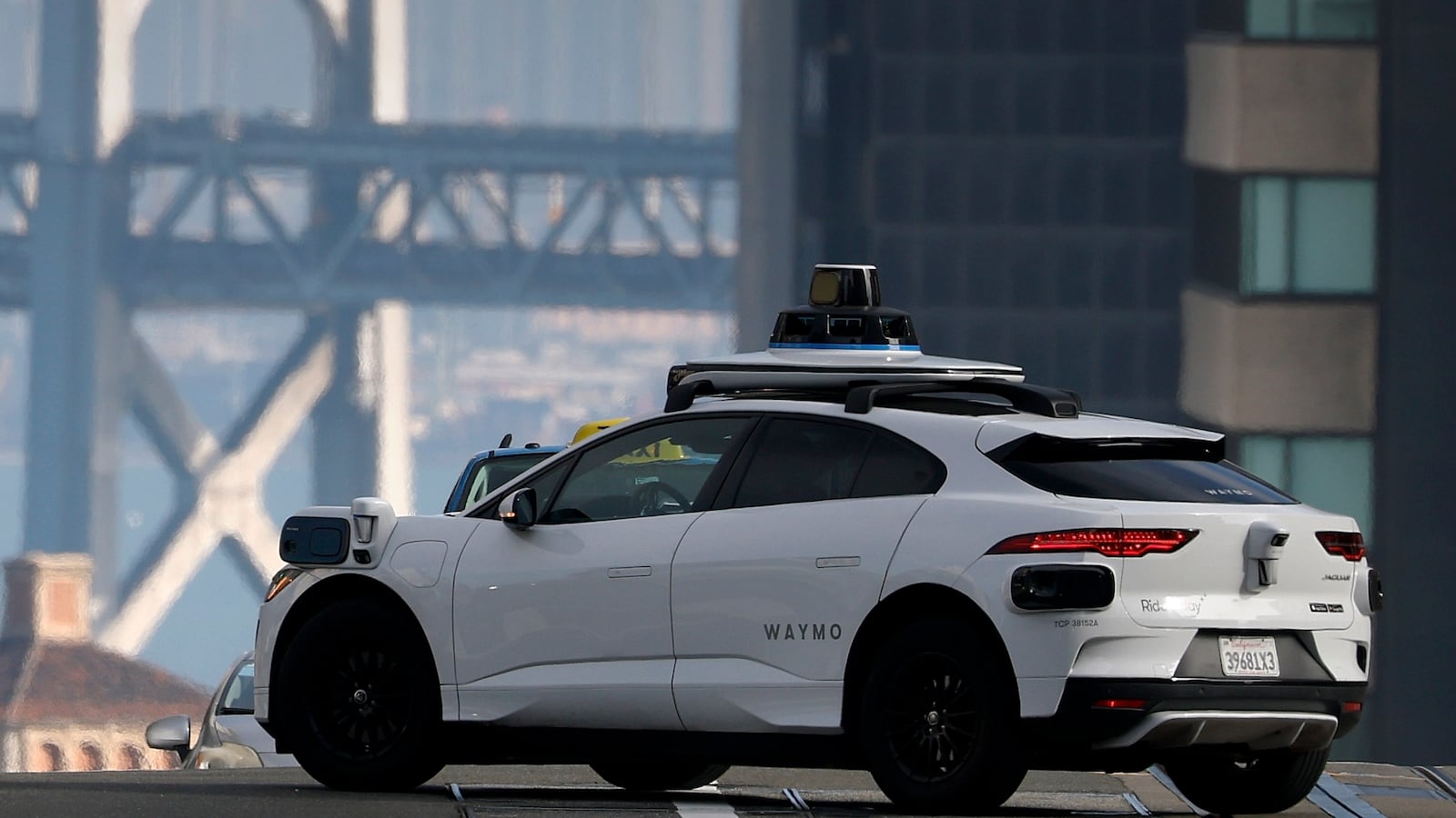 A Waymo robotaxi drives along California Street on December 08, 2025