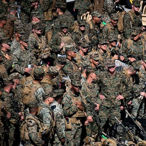 U.S. Marines with the 31st Marine Expeditionary Unit embark aboard the forward-deployed amphibious assault carrier USS Tripoli (LHA 7), at White Beach Naval Facility in Okinawa, Japan, Nov. 30, 2025.