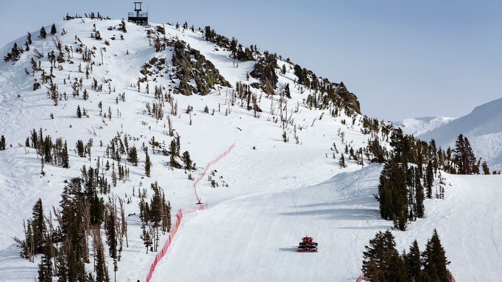 A snow-cat operator grooms an empty ski run at the popular Mammoth Mountain Ski Resort after closing time on April 16, 2024, in Mammoth Lakes, California.