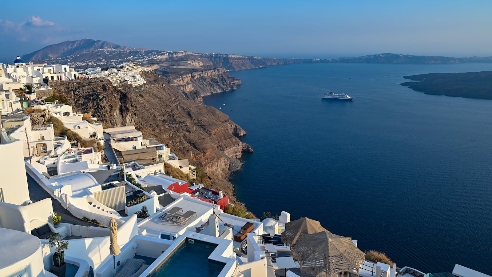 A view of the village of Imerovigli and the caldera in Santorini, Greece, on August 6, 2025, shows visitors returning to Santorini following the seismic activity earlier this year, but this iconic Greek island experiences a sharp decline in tourist numbers. (Photo by Nicolas Koutsokostas/NurPhoto via Getty Images)