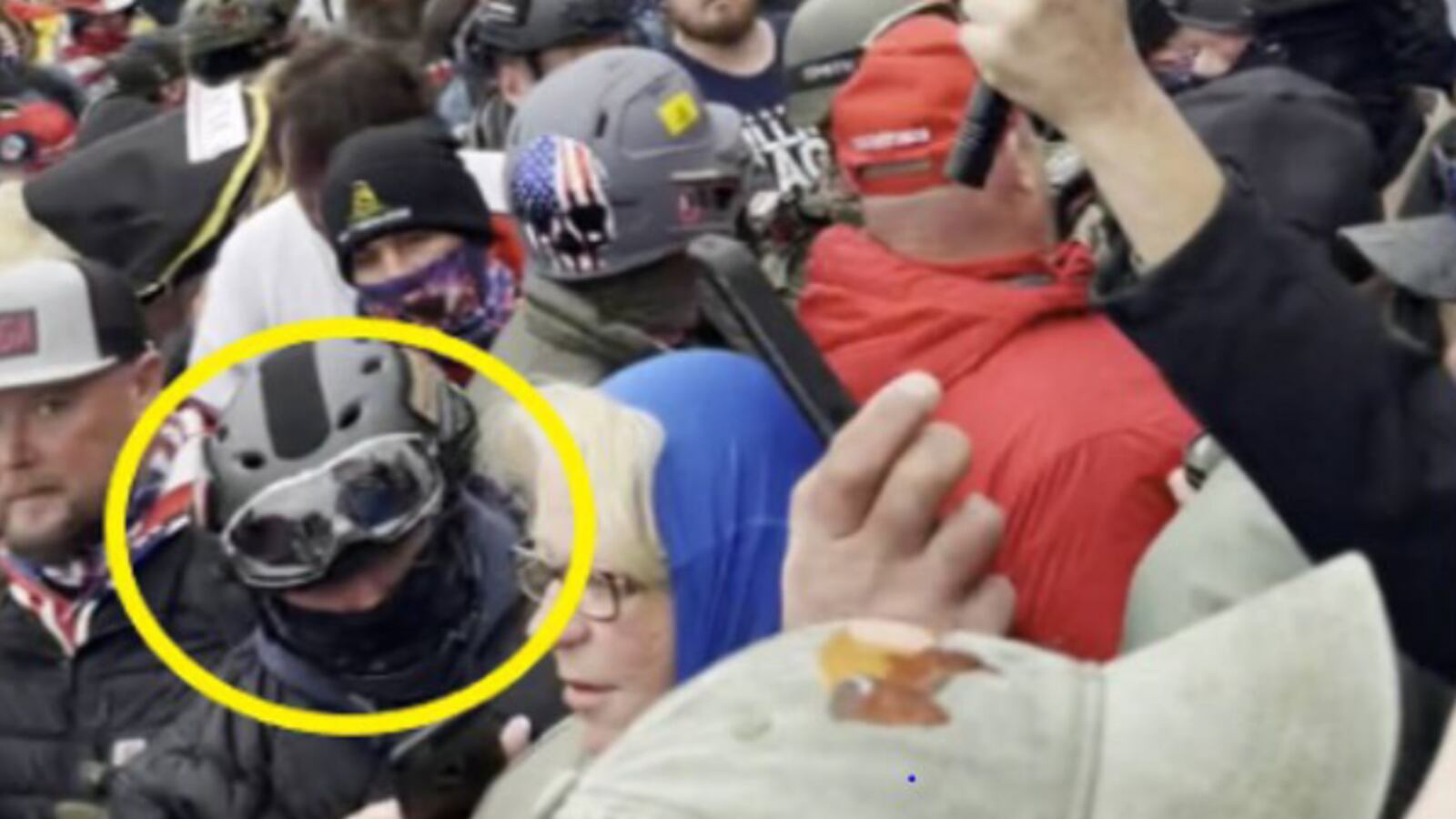 Joseph Pavlik, circled in yellow, wearing a gas mask among a crowd of Jan. 6 rioters