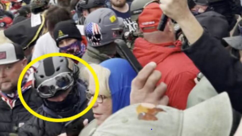 Joseph Pavlik, circled in yellow, wearing a gas mask among a crowd of Jan. 6 rioters