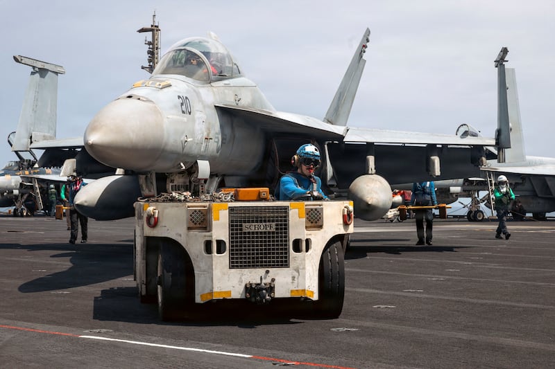 A U.S. Navy sailor moves an F/A-18F Super Hornet aircraft across the flight deck of the aircraft carrier USS Gerald R. Ford while underway at an undisclosed location, March 18, 2026. U.S. Navy/Handout via REUTERS. THIS IMAGE HAS BEEN SUPPLIED BY A THIRD PARTY