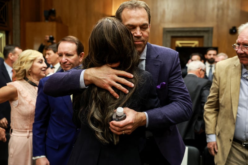 Kristi Noem, U.S. President-elect Donald Trump's secretary of Homeland Security nominee, hugs her husband Bryon Noem, on the day she testifies during a Senate Homeland Security and Governmental Affairs Committee confirmation hearing on Capitol Hill in Washington, U.S., January 17, 2025. REUTERS/Evelyn Hockstein