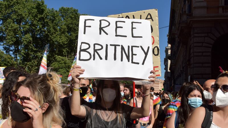 ROME, ITALY - JUNE 26: People with a sign saying Free Britney, referring to Britney Spears take part in Rome Pride, the LGBTQIA+ parade, on June 26, 2021 in Rome, Italy. The Italian prime minister defended parliament after the Vatican requested a revision on an anti-discrimination draft bill that provides protection for LGBTQ persons, saying the new law could interfere with religious freedoms.