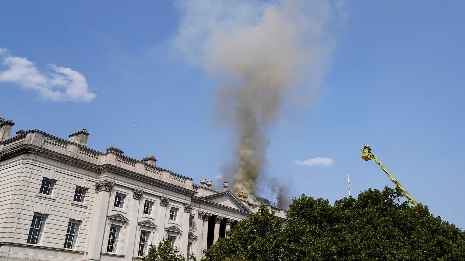 Smoke rises as firefighters work at the scene of a fire at Somerset House