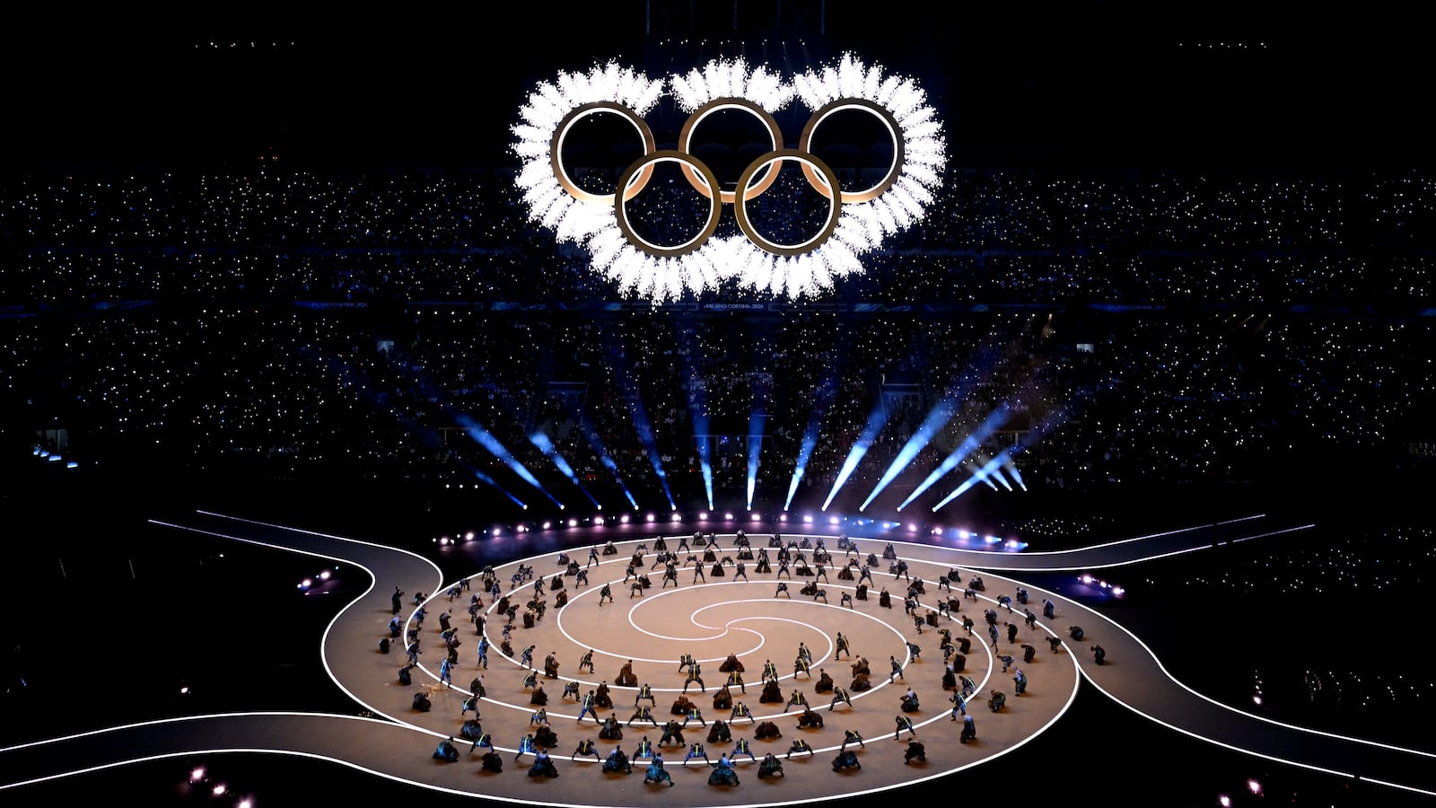A general view as the Olympic rings come together for a fireworks display during the opening ceremony of the Milano Cortina 2026 Winter Olympics at San Siro Stadium.