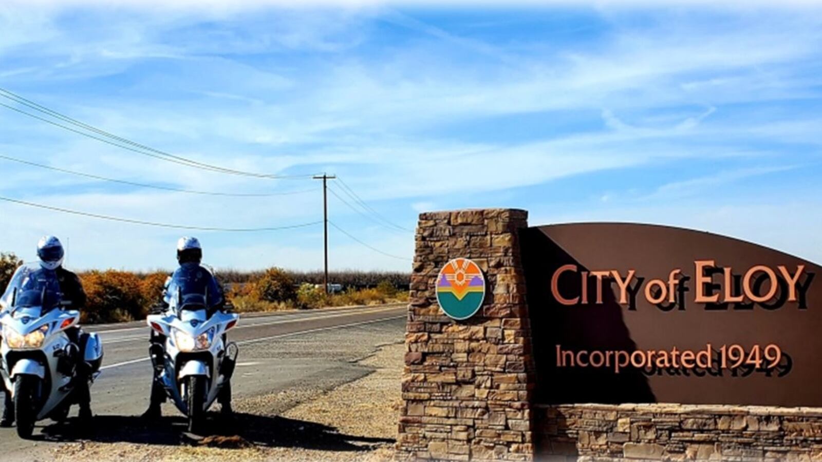 Eloy police alongside a city of Eloy sign