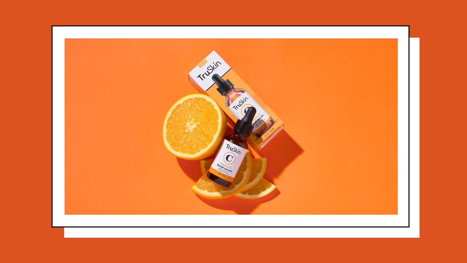 TruSkin Vitamin C Facial Serum bottle and packaging with fresh orange slices on a vibrant orange background, highlighting the serum's citrus-based skincare benefits.
