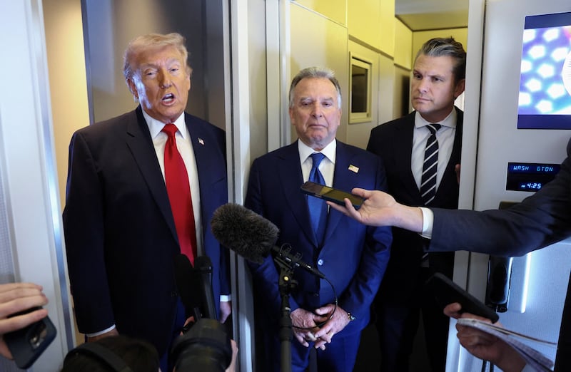 U.S. President Donald Trump, with Middle East envoy Steve Witkoff and Secretary of Defense Pete Hegseth at his side, speaks to reporters aboard Air Force One on a flight from Dover, Delaware, to Miami, Florida, U.S., March 7, 2026.
