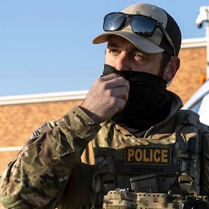 U.S. Border Patrol agents stop an activist from approaching as a shopper is questioned outside a Home Depot store on November 19, 2025 in Charlotte, North Carolina.