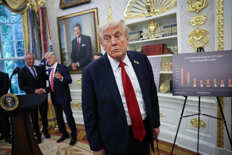 President Donald Trump listens to a question from a reporter after announcing a deal with Pfizer to lower Medicaid drug prices
