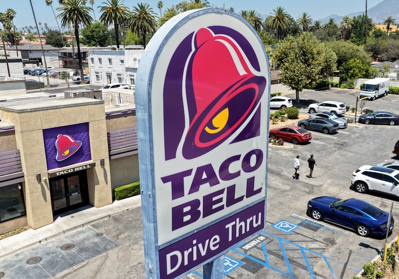 PASADENA, CALIFORNIA - JULY 14: In an aerial view, customers depart a Taco Bell restaurant on July 14, 2026 in Pasadena, California. Federal and state health officials have reportedly begun investigating whether lettuce served at some Taco Bell restaurants has led to the widespread outbreak of cyclosporiasis, a gastrointestinal illness, which has sickened thousands around the country. (Photo by Mario Tama/Getty Images)