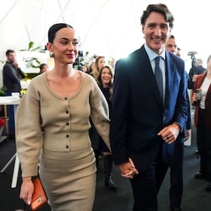 Former Prime Minister Justin Trudeau holds hands with Katy Perry as they leave an event during the World Economic Forum in Davos, Switzerland on Tuesday, Jan. 20, 2026.