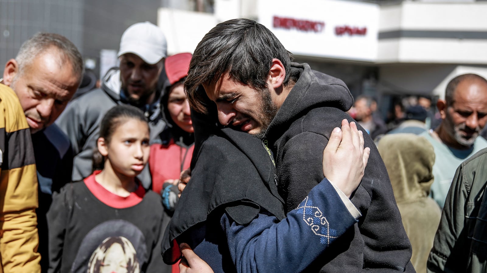 People mourn following an early morning incident when residents rushed toward aid trucks in Gaza City on February 29, 2024.