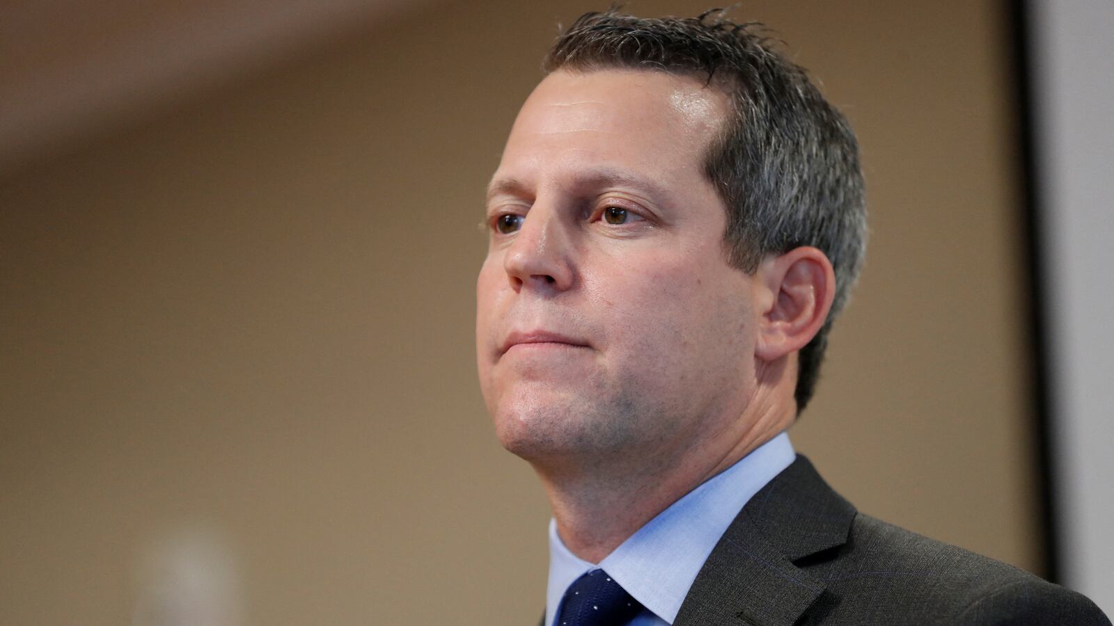 Andrew Warren stares forward as he addresses media in a press conference.