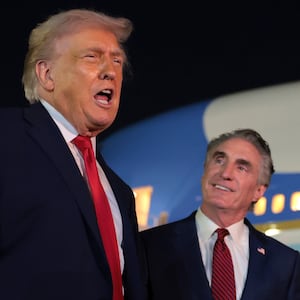 WEST PALM BEACH, FLORIDA - JANUARY 19: U.S. President Donald Trump (L) talks with reporters as U.S. Secretary of the Interior Doug Burgum (R) looks on at Palm Beach International Airport on January 19, 2026 in West Palm Beach, Florida. President Trump attended this year’s college football national championship game at Hard Rock Stadium between the Indiana Hoosiers and the Miami Hurricanes. (Photo by Anna Moneymaker/Getty Images)