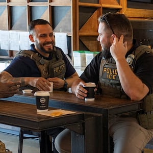 United States Immigration and Customs Enforcement (ICE) agents gather at a coffee shop, after hundreds of Immigration and Customs Enforcement agents were ordered to deploy to airports to help fill TSA staffing gaps, at Luis Munoz Marin International Airport in Carolina, Puerto Rico, March 24, 2026. REUTERS/Ricardo Arduengo