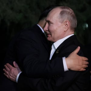 Russian President Vladimir Putin and Chinese President Xi Jinping hug