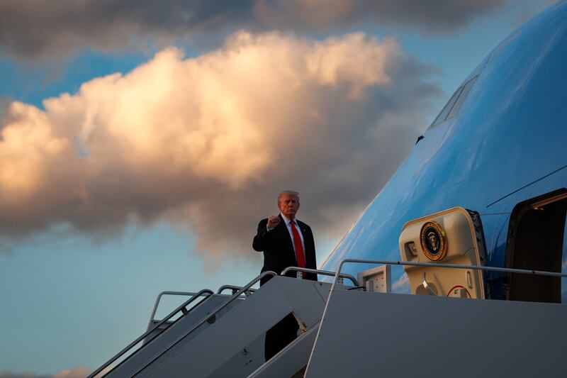 President Donald Trump poses as he boards Air Force One en route to the White House on November 2, 2025 at Palm Beach International Airport. Trump spent the weekend at his Mar-A-Lago estate in Florida.