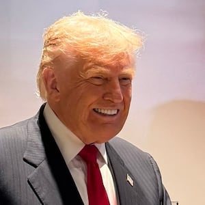 Trump's right hand was caked in makeup as he received a gift from the Commanders' owner. Margo Martin/White House