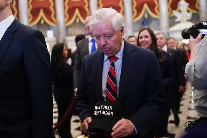 U.S. Senator Lindsey Graham (R-SC) holds a hat reading "Make Iran Great Again" as he arrives for U.S. President Donald Trump's State of the Union address to a joint session of Congress at the U.S. Capitol in Washington, D.C., U.S., February 24, 2026. REUTERS/Nathan Howard