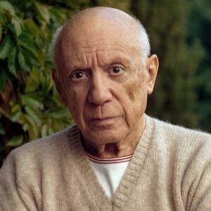 MOUGINS, FRANCE - 1966 : Pablo Picasso standing by a green fern with folded arms, wearing a cashmere sweater. (Photo by Tony Vaccaro / Getty Images)