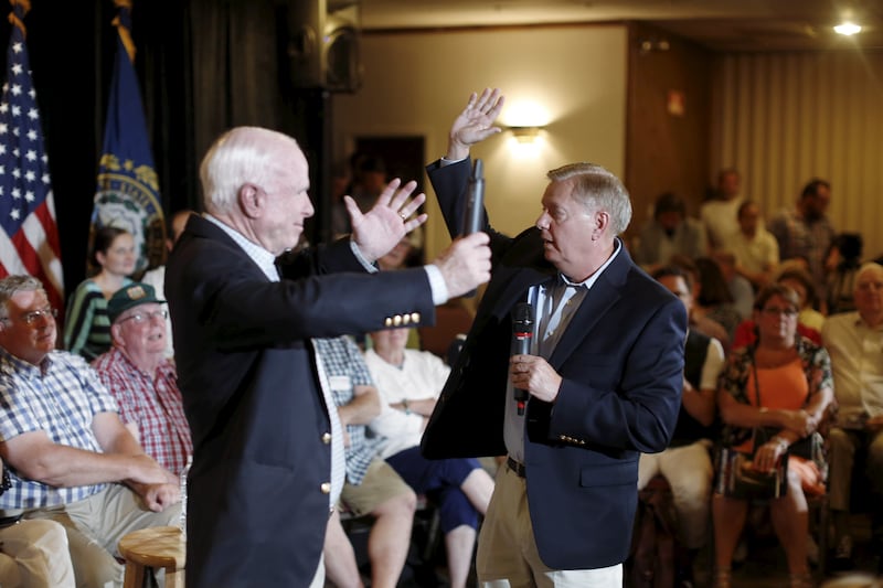South Carolina Senator and U.S. Republican presidential candidate Lindsey Graham gestures with Arizona Senator and 2008 Republican presidential nominee John McCain