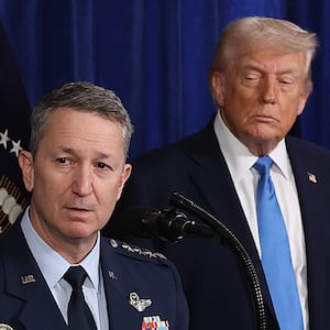President Donald Trump with his eyes closed as Chairman of the Joint Chiefs of Staff Dan Caine speaks during a press conference at Mar-a-Lago club on January 03, 2026, in Palm Beach, Florida.