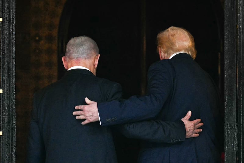 US President Donald Trump (R) and Israeli Prime Minister Benjamin Netanyahu (L) walk inside after Netanyahu arrived at Trump's Mar-a-Lago residence in Palm Beach, Florida, on December 29, 2025.