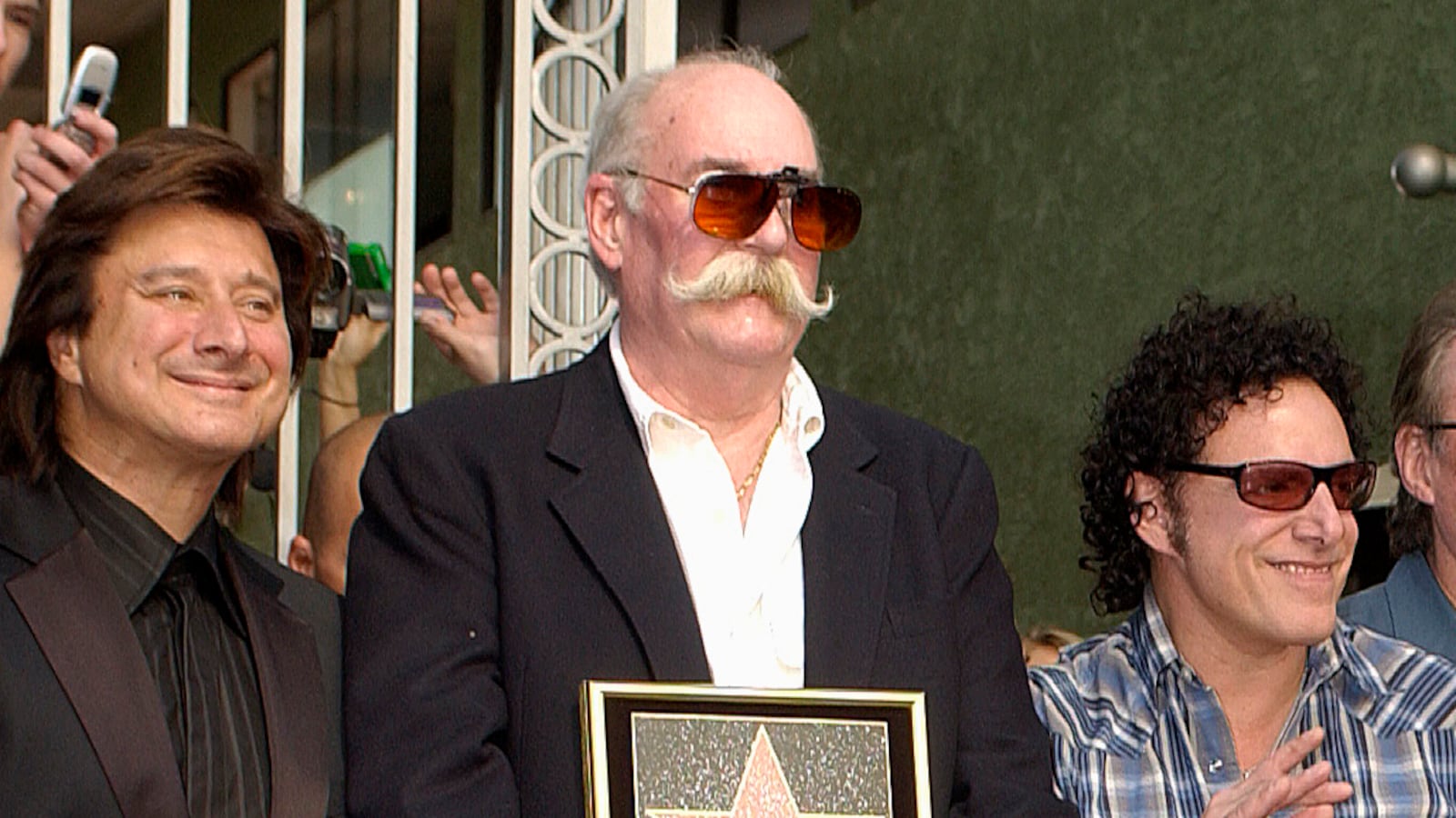 George Tickner, center, with Steve Perry and Neal Schon at Journey’s Hollywood Walk of Fame ceremony