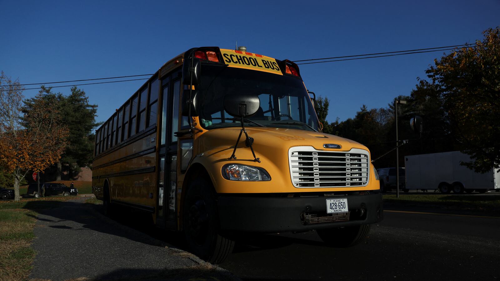 A yellow school bus on the street.