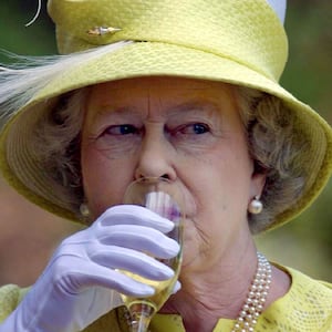 Queen Elizabeth II takes a sip of wine during a wine country tour in Adelaide, February 28, 2002.