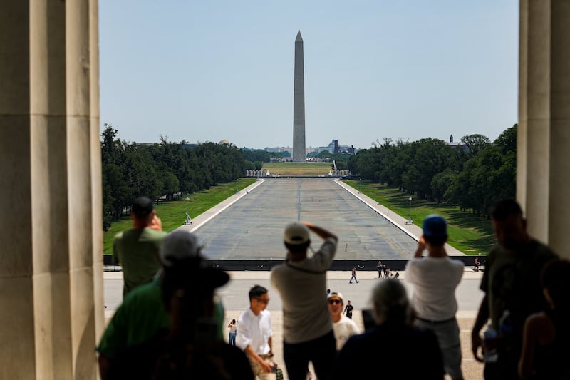 People look towards the drained Lincoln Memorial Reflecting Pool, following renovations and Independence Day celebrations, in Washington, D.C., U.S., July 15, 2026.