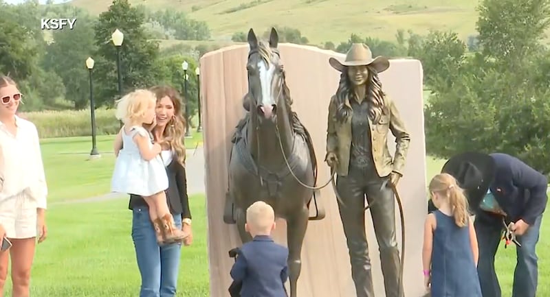 Former Homeland Security Secretary Kristi “ICE Barbie” Noem unveils a life-sized statue honoring her governorship in Pierre, South Dakota, on Aug. 7.