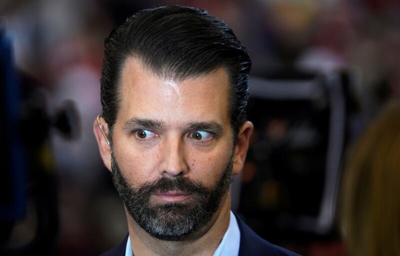 Donald Trump Jr. talks to a reporter before his father holds a campaign rally in Manchester, New Hampshire.