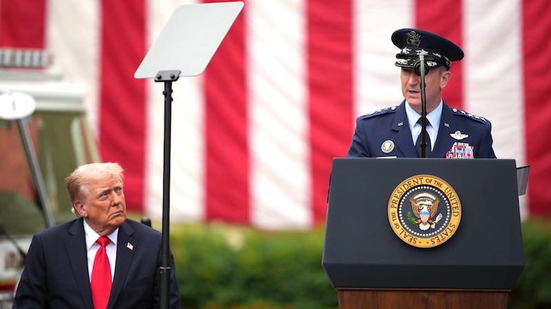 U.S. President Donald Trump listens as Chairman of the Joint Chiefs of Staff Air Force Gen. Dan Caine