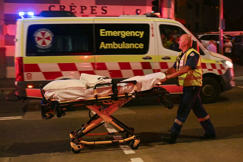 A health worker moves a stretcher after a shooting incident at Bondi Beach.