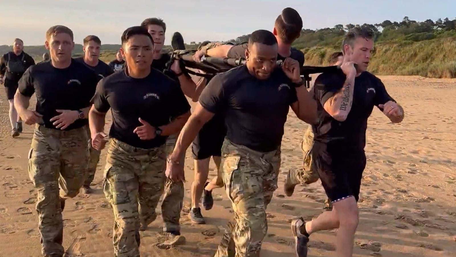 Pete Hegseth (right) takes part in personal training with troops on Omaha Beach.